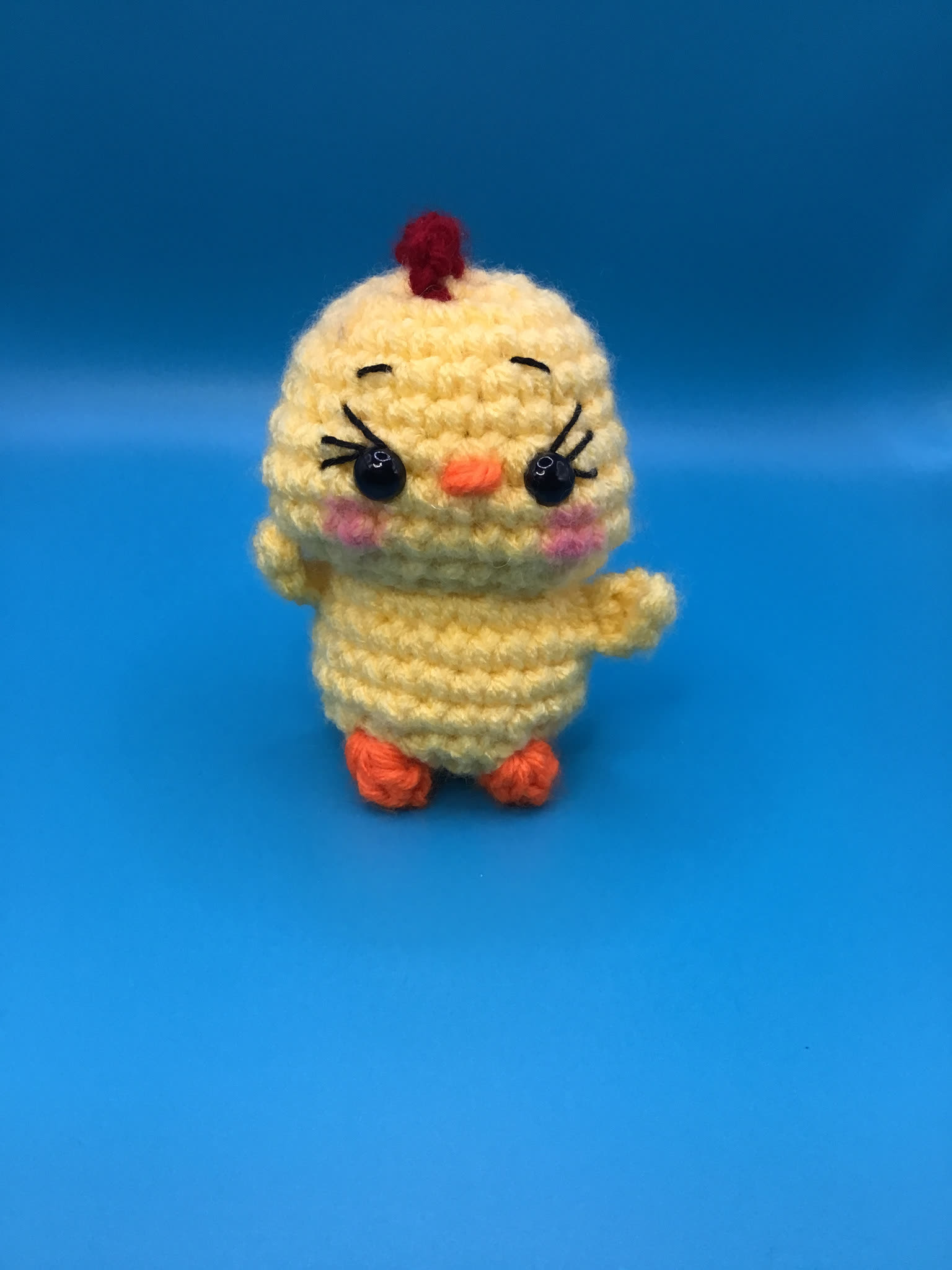 Small cheerful crocheted yellow chick